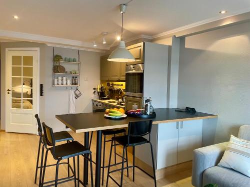 a kitchen with a table and chairs in a room at Svolvær Harbour Sea View Apt in Svolvær