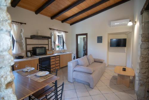 a living room with a couch and a table at Saralen cottage in North Corfu 