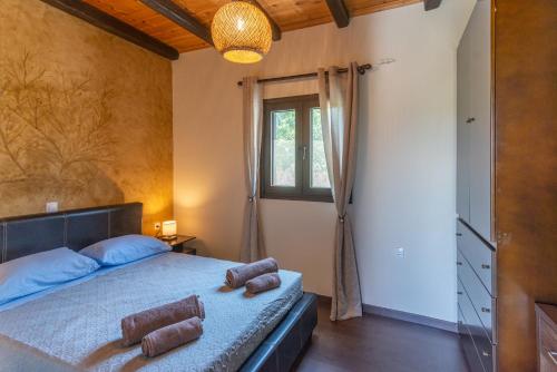 a bedroom with a bed and a window at Saralen cottage in North Corfu 