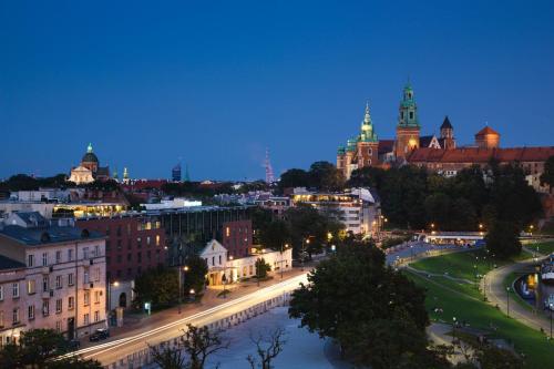 a view of a city at night at Sheraton Grand Krakow in Kraków