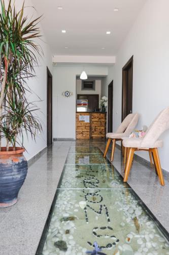 a living room with a floor with a koi pond at Nefelis Rooms in Himare