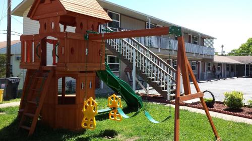 a playground in front of a building with a slide at Hunter's Friend Resort on Indian Point in Branson