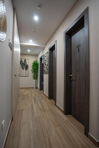 a hallway with a wooden door and wooden floors at Bed&Breakfast Novalis in Novalja