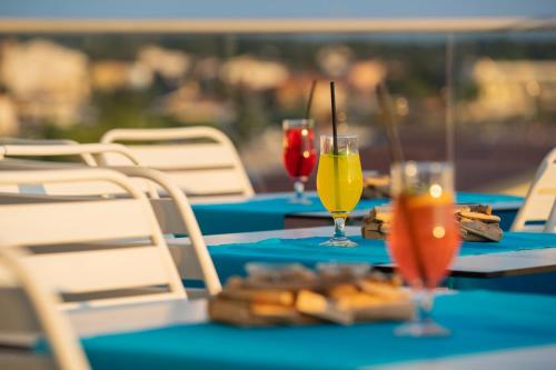 two tables with drinks and snacks on them at Bed&Breakfast Novalis in Novalja