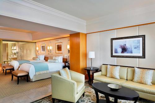 a hotel room with a bed and a living room at Ritz Carlton DIFC Downtown Dubai in Dubai