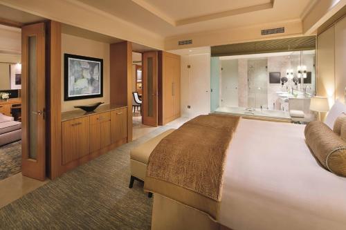 a large bedroom with a large bed and a bathroom at Ritz Carlton DIFC Downtown Dubai in Dubai