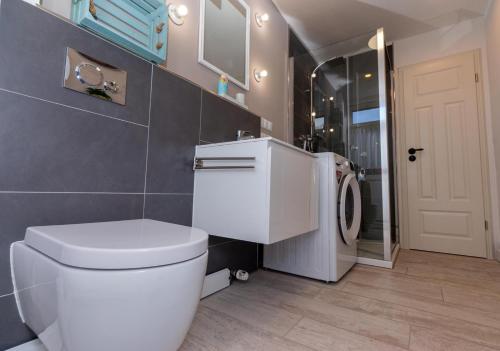 a bathroom with a white toilet and a shower at Temporary Living - Rest and Relax in Eisenach