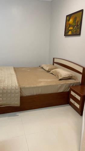 a bedroom with a bed with a wooden frame and a table at غرفه ديلوكس ٤٥م بقلب المدينه بالقرب من المسجد المبوي in Medina