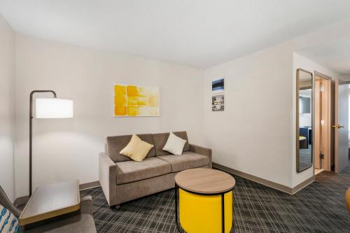 a living room with a couch and a table at Comfort Inn & Suites Hampton near Coliseum in Hampton