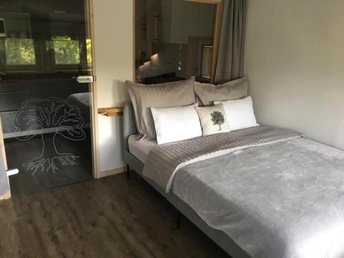 a bed with two pillows on it in a room at Oak apartment in Březnice