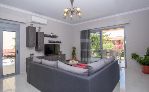 a living room with a couch and a table at Liri's Apartments in Kalamaki