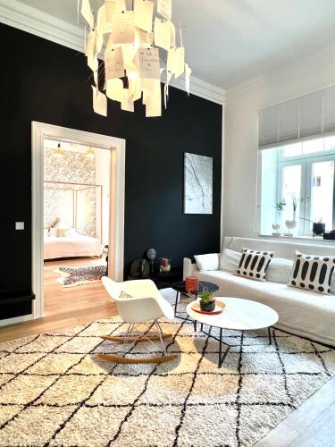 a living room with a couch and a table at Puro-Design-Apartment Deluxe - very central in Munich