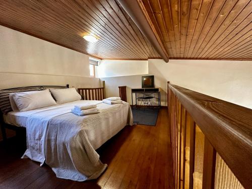 a bedroom with a bed with a wooden ceiling at Maisonette Nineta in Heraklio