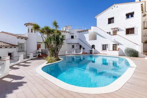 a swimming pool in front of a house at Tot Gaviota in Sitges
