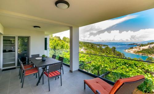 a dining room with a view of the ocean at Apartment Sweet Dream Manjiga in Nečujam