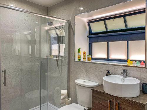 a bathroom with a toilet and a sink and a shower at Tranquillity-uk38552 in Endon