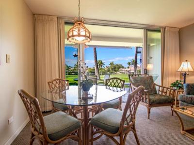 a dining room with a table and chairs and a window at Kaanapali Maui at the Eldorado by OUTRIGGER in Lahaina
