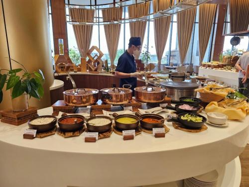 a chef preparing food on a buffet table at Wyndham Grand KN Paradise Cam Ranh in Cam Ranh