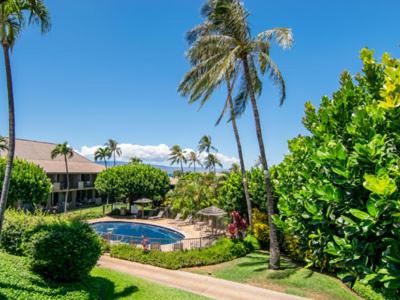 a resort with a swimming pool and palm trees at Kaanapali Maui at the Eldorado by OUTRIGGER in Lahaina