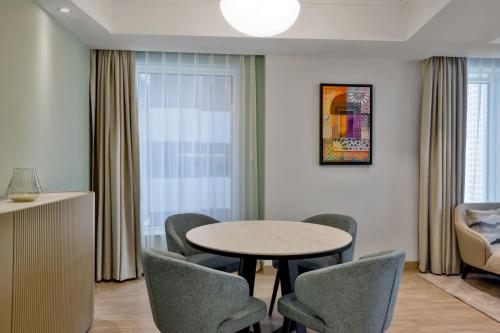 a dining room with a table and chairs at Residence Inn by Marriott Sheikh Zayed Road, Dubai in Dubai