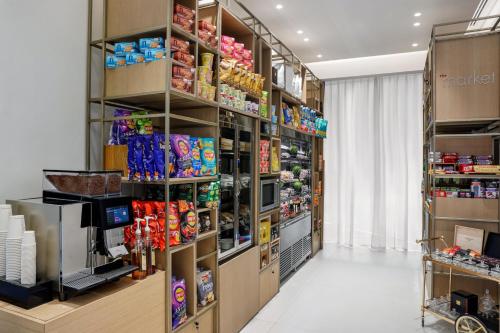a store aisle with shelves of food and snacks at Residence Inn by Marriott Sheikh Zayed Road, Dubai in Dubai