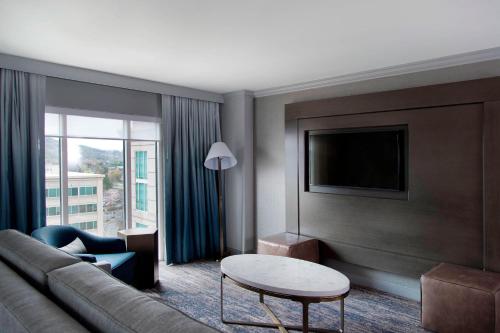a living room with a couch and a table at Franklin Marriott Cool Springs in Franklin