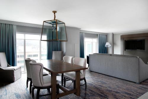 a living room with a table and chairs and a couch at Franklin Marriott Cool Springs in Franklin