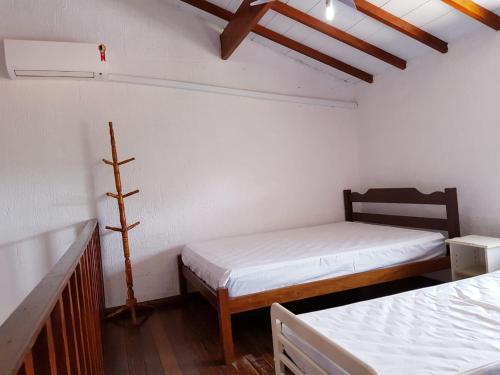 a room with two beds in a room at Recanto Vizinho do Mar in Ubatuba