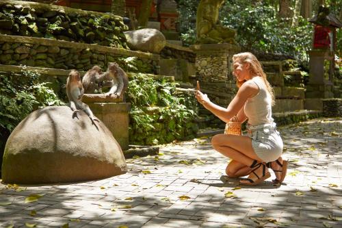 a woman feeding a monkey at a zoo at Element Bali Ubud in Ubud
