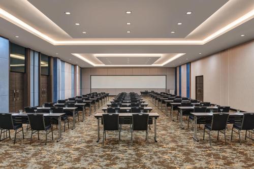 a large room with rows of tables and chairs at Palm Garden Hotel, Putrajaya, a Tribute Portfolio Hotel in Putrajaya