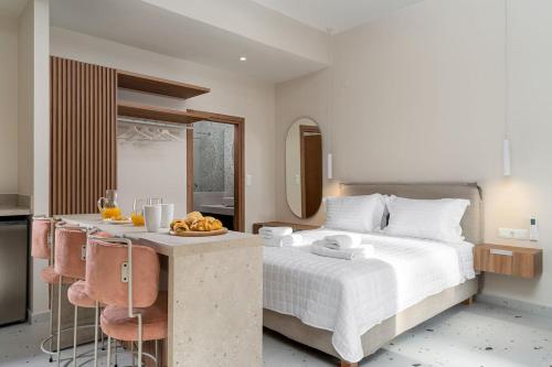 een slaapkamer met een bed en een tafel met fruit erop bij Ble Residence, Your Home Away from Home in Panormos Rethymno