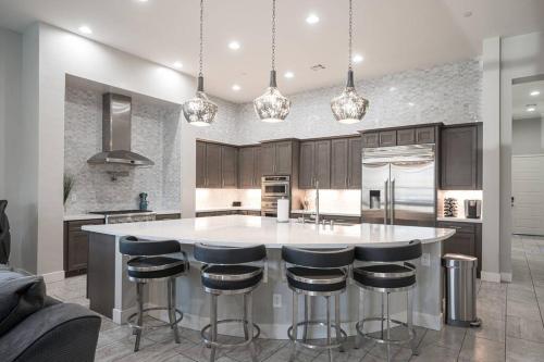 a kitchen with a large island with bar stools at Luxury home close to everything in Las Vegas