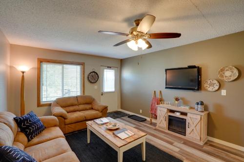 a living room with a couch and a ceiling fan at Sacajawea Suite 1 with Deck in Heart of Medora! in Medora