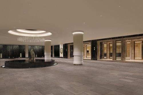 a lobby with a fountain in the middle of a building at The Westin Pune Koregaon Park in Pune