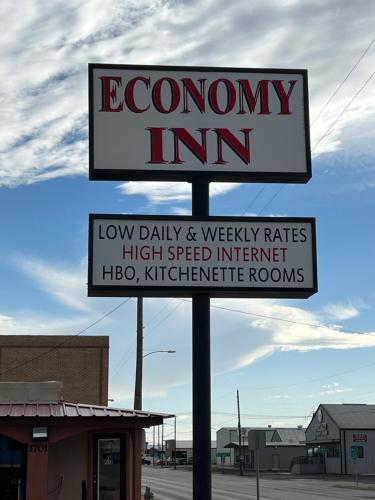 a sign for an economy inn in a parking lot at Economy Inn Odessa in Odessa