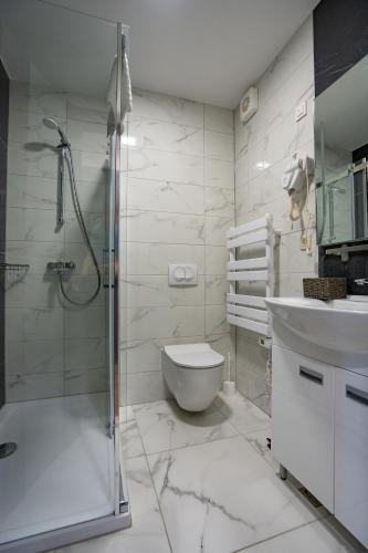a bathroom with a shower and a toilet and a sink at Bed&Breakfast Novalis in Novalja