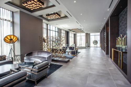 a lobby with couches and chairs in a building at The Row Hotel at Assembly Row, Autograph Collection in Somerville