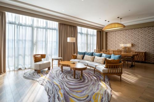 a living room with a couch and a table at Four Points by Sheraton Chengdu, Pujiang Resort in Pujiang