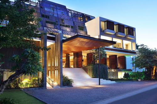 a large building with a staircase in front of it at Four Points by Sheraton Bali, Seminyak in Seminyak