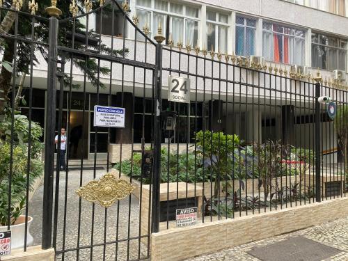 a building with a gate with a bunch of plants at Apartament in Flamengo in Rio de Janeiro