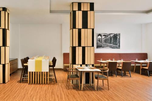 a dining room with tables and chairs in a room at Fairfield by Marriott Chennai Mahindra World City in Chengalpattu