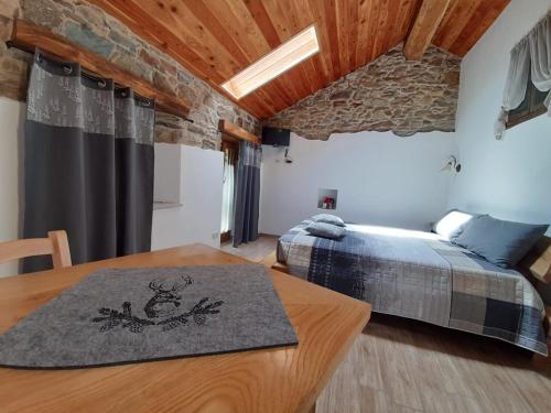 a bedroom with a bed and a wooden table at Bed & Breakfast La Crotta in Pont-Saint-Martin