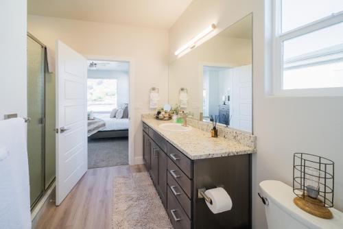 a bathroom with a sink and a mirror at Painted Desert-4Bed, 3Bath, Hot Tub, Deck in Hildale