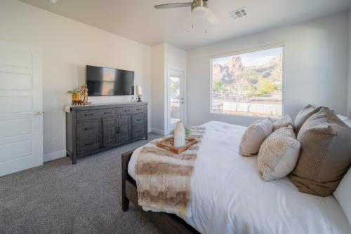 a bedroom with a bed with a television and a dresser at Painted Desert-4Bed, 3Bath, Hot Tub, Deck in Hildale