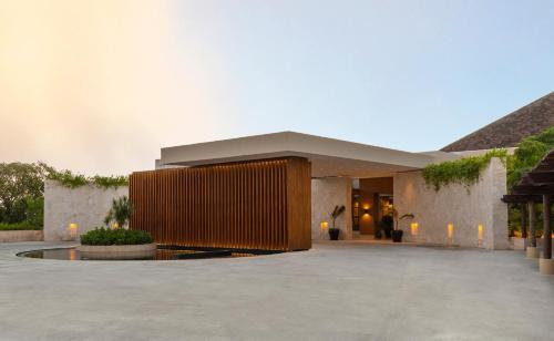 a building with a lobby with a large building at Fairmont Mayakoba in Playa del Carmen