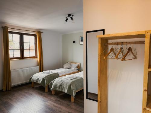 a room with two beds and a window at Pensiunea Oacheș in Sălaşu de Sus