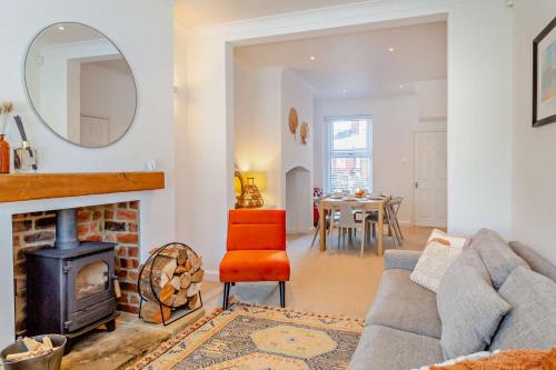 a living room with a couch and a fireplace at 3-bedroom home with free parking&flexible bed configuration in Harrogate