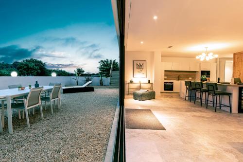 two views of a kitchen and a living room and a dining room at Villa Juliane in Cadenet