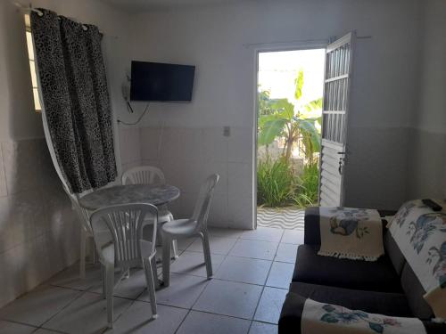 a living room with a table and chairs and a couch at Ap 04-A 50 Metros da Praia Flats Mobiliados para 2 Pessoas in Paulista