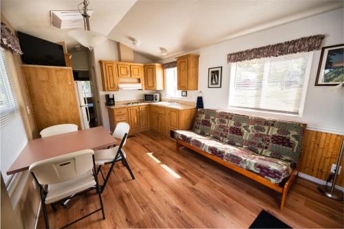 a living room with a couch and a table at Mountain Gate RV Park and Cottages in Redding